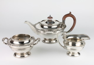 A good 3 piece silver tea set with scroll egg and dart decoration, the handles with serpent finials with fruitwood mounts, Sheffield 1927, maker Walker & Hall, gross weight 1730 grams 