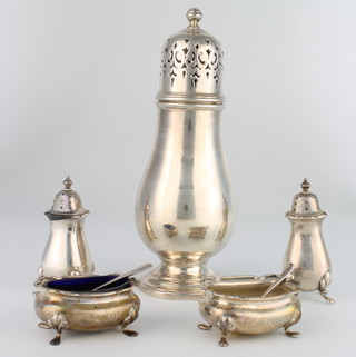 A silver 4 piece condiment comprising 2 peppers, 2 salts and 2 spoons, Birmingham 1902, 136 grams and a plated sugar sifter