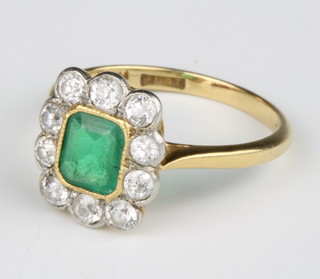 An 18ct yellow gold emerald and diamond cluster ring, the centre stone approx. 0.6ct surrounded by 10 brilliant cut diamonds approx. 0.5ct. size L 1/2