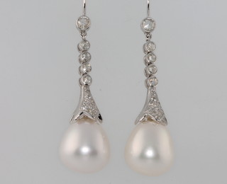 A pair of 18ct white gold cultured pearl and baguette cut diamond earrings, approx. 0.58ct 