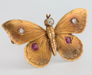 An Edwardian 18ct yellow gold novelty brooch in the form of a butterfly set with 3 brilliant cut diamonds and 2 brilliant cut rubies, 48mm x 25mm 