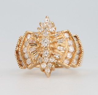 A 14ct yellow gold diamond ring comprising 35 brilliant cut diamonds and 8 baguette cut diamonds size N