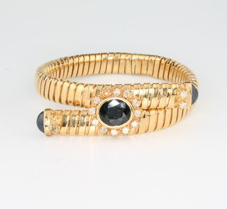 An 18ct yellow gold articulated bracelet set with a oval cut sapphire and 2 cabochon cut dittos, surrounded by brilliant cut diamonds 17.5cm 