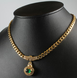 An 18ct yellow gold flat link necklace set with an oval cabochon cut emerald surrounded by brilliant cut diamonds, suspended from a cabochon cut emerald and diamond support, 54.7 grams gross, 38cm 