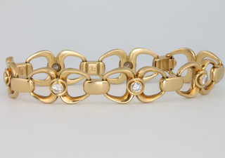 Leo De Vroomen, an 18ct yellow gold open link bracelet set with 7 brilliant cut diamonds each approx. 0.15ct, 33 grams gross, 17.5cm 