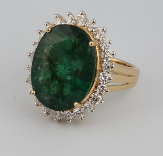 An 18ct yellow gold oval emerald and diamond cluster ring approx. 8.92ct surrounded by brilliant cut diamonds approx. 0.87ct size N 