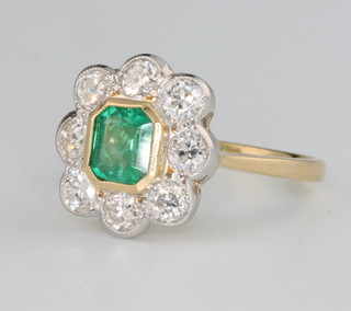 An 18ct yellow gold emerald and diamond cluster ring, the centre stone approx. 0.8ct surrounded by 8 brilliant cut diamonds approx. 1.1ct size O