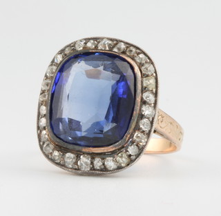 A sapphire and diamond yellow gold ring, the centre stone approx. 15mm x 12mm surrounded by 28 diamond chips size N 