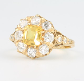 An 18ct yellow gold yellow sapphire and diamond ring, the centre stone approx. 1.4ct surrounded by 14 brilliant cut diamonds size N 1/2