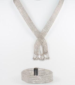 An 18ct white gold mesh necklace with tassle terminals 39cm and an ensuite bracelet 17cm, 52.3 grams  