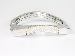 A Torrini 18ct white gold chased bangle set with brilliant cut diamonds and yellow sapphires 72 grams 