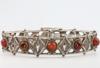 A silver hardstone bracelet and a pair of silver gem set ear studs