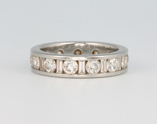 A platinum eternity ring comprising 13 brilliant and 13 baguette cut diamonds, 2ct, size J  