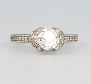 A platinum and diamond ring, the centre brilliant cut stone approx. 1ct set in a high claw mount flanked by 48 brilliant cut diamonds approx. 0.3ct, size M