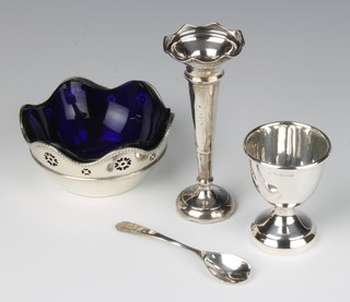 A silver bowl with blue glass liner Birmingham 1925, an egg cup, spill vase and spoon, weighable silver 84 grams 