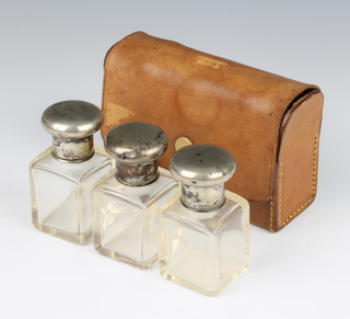A set of 3 800 mounted scent bottles in a leather case 7cm 