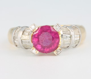 A yellow gold ruby and diamond ring, the centre brilliant cut treated stone approx. 1.25ct flanked by tapered baguette and brilliant cut diamonds size R 