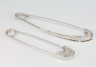 Two 18ct white gold diamond pendants in the form of safety pins 
