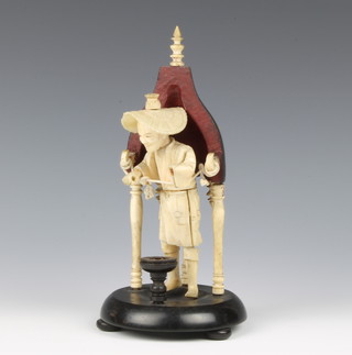 A Japanese ivory okimono of a gentleman on a later wooden and bone stand 5"