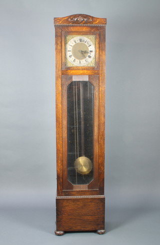 A 1920's 8 day striking longcase clock with 27cm gilt square dial, gilt spandrels, silvered chapter ring, striking on gongs, contained in a carved oak case 190cm h 