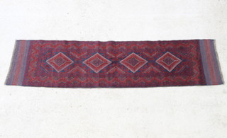A red and blue ground Meshwani runner with 6 stylised octagons within a multirow border 270cm x 63cm 