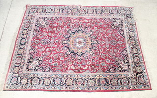 A red ground Persian Kharassan carpet with central medallion within multirow borders 334cm x 306cm