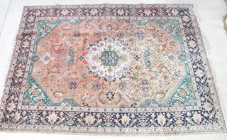 An orange, green and blue ground Tabriz carpet with central medallion, floral motifs 391cm x 278cm 