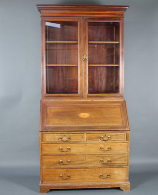 Maple & Co Ltd, an Edwardian bleached inlaid mahogany bureau bookcase, the upper section with moulded cornice, fitted shelves enclosed by glazed panelled doors, the fall front revealing a fitted interior above 2 short and 3 long drawers with brass swan neck drop handles 224cm h x 103cm w x 59cm d 
