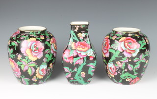 A pair of 1930's black ground baluster vases decorated with peony 16cm, a baluster square do. 18cm 
