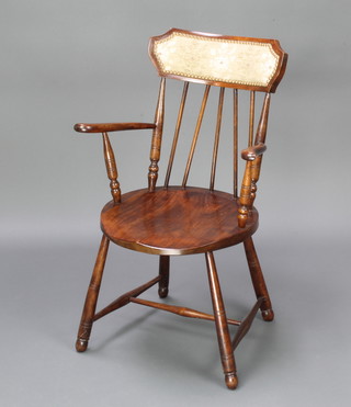 An Edwardian beech stick and rail back open arm chair with solid seat, raised on turned supports with H framed stretcher