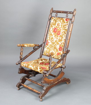 A 19th Century turned American beech rocking chair raised on turned supports 
