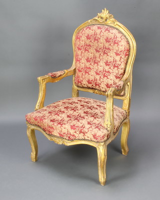 A French style gilt painted open arm chair with upholstered seat and back raised on cabriole supports 