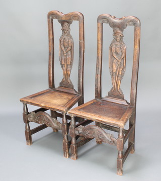 A pair of Continental carved oak slat back hall chairs, the slats carved figures of knights, with solid seats raised on turned and block supports 