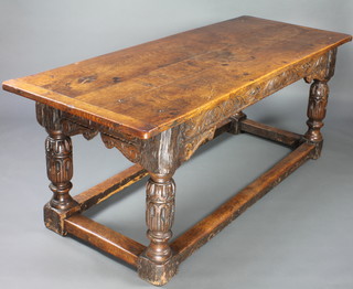 A 17th/18th Century oak refectory dining table with 3 plank top and carved apron, raised on turned cup and cover supports with box framed stretcher 75cm h x 187cm w x 76cm d