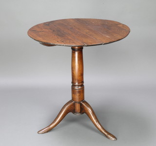 An 18th Century circular snap top tea table raised on gun barrel and tripod supports 71cm h x 68 diam. 