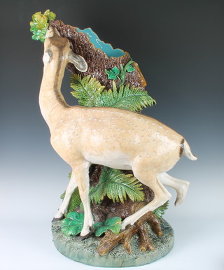 Minton Majolica modelled by Paul Comolera.  A good Majolica stick stand depicting a deer standing beside a tree trunk applied with acorns and leaves, the rustic base with ferns impressed (model number) 2077, impressed P Comolera, 84cm high 