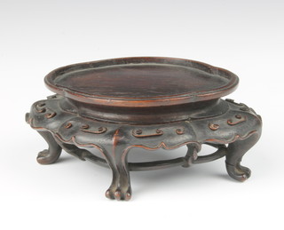 A 19th Century Chinese carved hardwood vase stand of quatrefoil shape of simple geometric design on pad feet 11cm x 8.5cm 