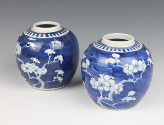 A near pair of blue and white prunus jars 14cm 
