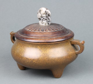 An 18th century style Chinese bronze censer of simple form with hoop handles raised on three short legs the base with Qing dynasty seal mark 17.5 cm the carved petal decorated hardwood lid with a soapstone fruit knop