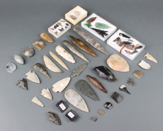A collection of various flint arrowheads, 2 "sling shots" etc 