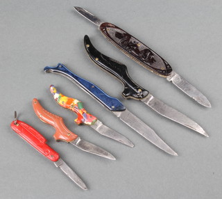 3 early 20th Century shoe knives, 2 with grips in the form of shoes and one knife in the form of a female stockinged leg  