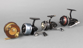 A brass and mahogany star back centre pin fishing reel 7cm, a Mitchell 300 reel, a K.P Morritt's intrepid Envoy reel and an Abu 50G reel  