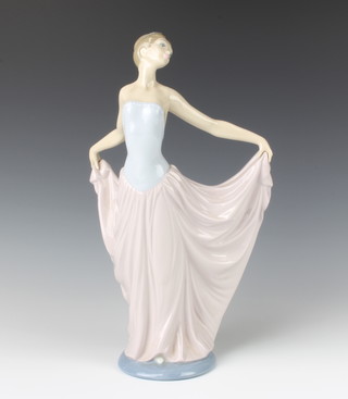 A Lladro figure of a lady holding out her dress 31cm 