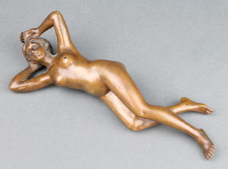An Art Nouveau novelty erotic bronze figure of a reclining naked lady 17cm x 3cm x 3cm. The back with a removable hatch containing a pressure plate to be linked to an external battery. Upon pressure to the left nipple an electric shock is discharged