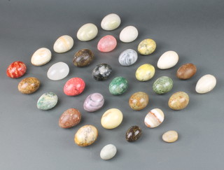 A collection of polished hardstone egg hand coolers