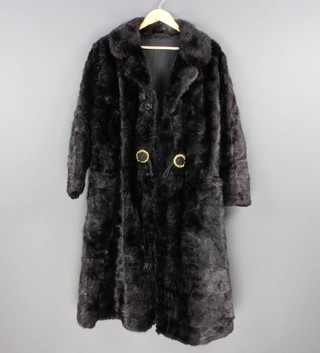 A lady's full length black fur coat 
