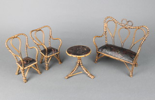 A miniature bamboo effect 2 seat open arm settee 18cm x 19cm x 8cm, 2 matching armchairs and a circular pedestal table 10cm h x 9cm diam. (stretcher damaged) 