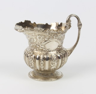 A Victorian repousse silver cream jug with floral decoration London 1899, 9cm,  126 grams