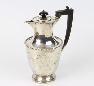 A silver coffee pot with chased ribbon, swags and festoons with ebony mounts 21.5cm, 546 grams gross 