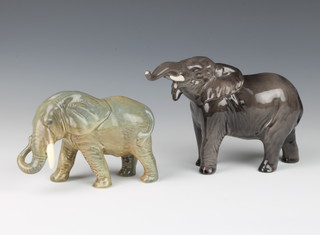 A Beswick figure of a standing elephant with trunk stretching forward no. 974 modelled by Arthur Gredington 12.1 cm, a similar elephant unmarked 9cm 